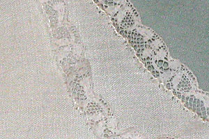 Detail of the precise hand stitching on a Whispering gown. Click image for a larger view.