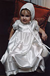 Gown 1: Heirloom lace inserts detail this silk charmeuse Christening gown.